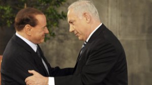Israeli Prime Minister Benjamin Netanyahu, right, and Italian Prime Minister Silvio Berlusconi, left, are seen during a welcome ceremony at Netanyahu's office in Jerusalem on Monday.