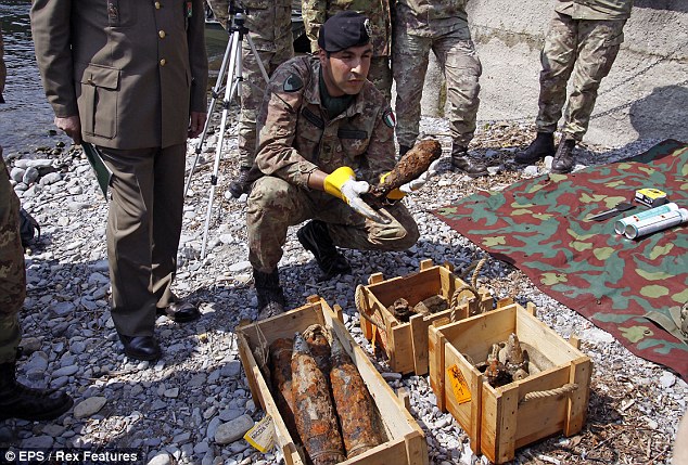 The Italian navy display some of the unexploded ordinance after rescuing it from the water outside Clooney's home today